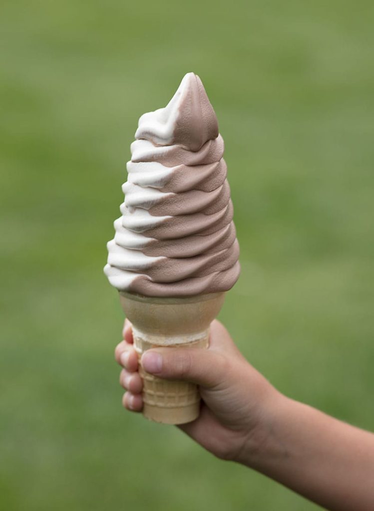 someone holding an ice cream cone.